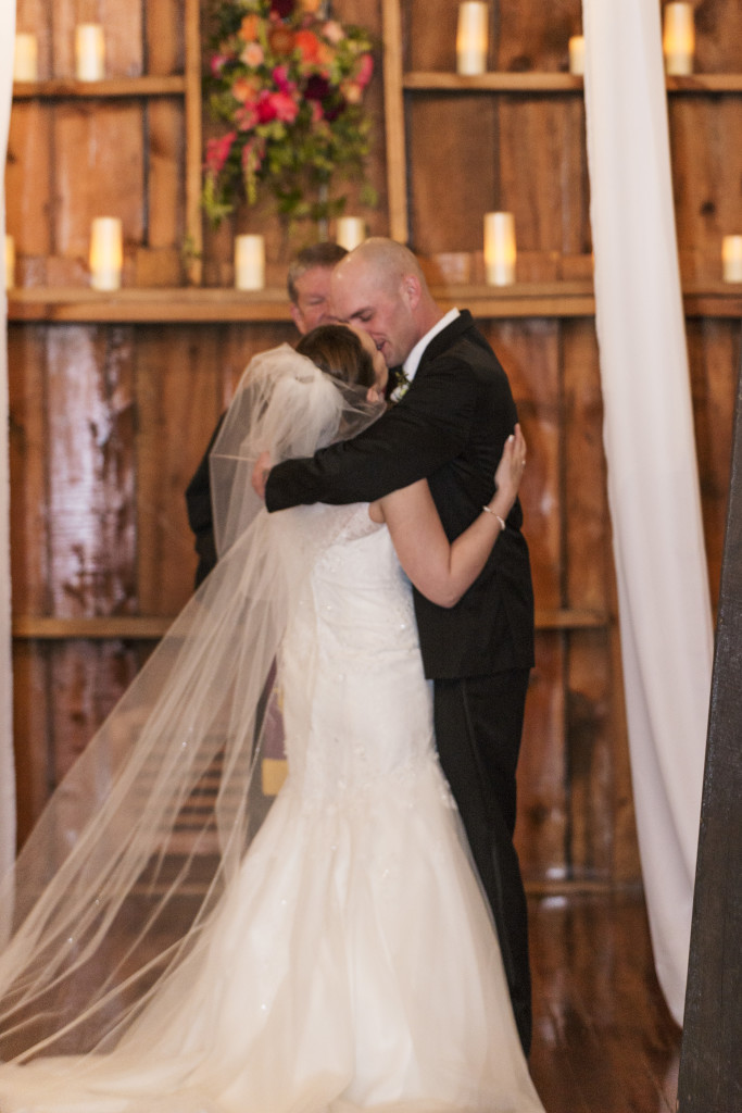 Bride and groom kiss at the end of their wedding ceremony at Crooked Willow Farm