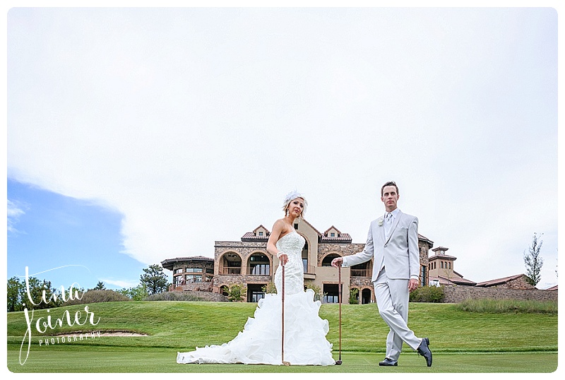 bride and groom are standing on the golf course holding golf clubs with flying horse club behind them
