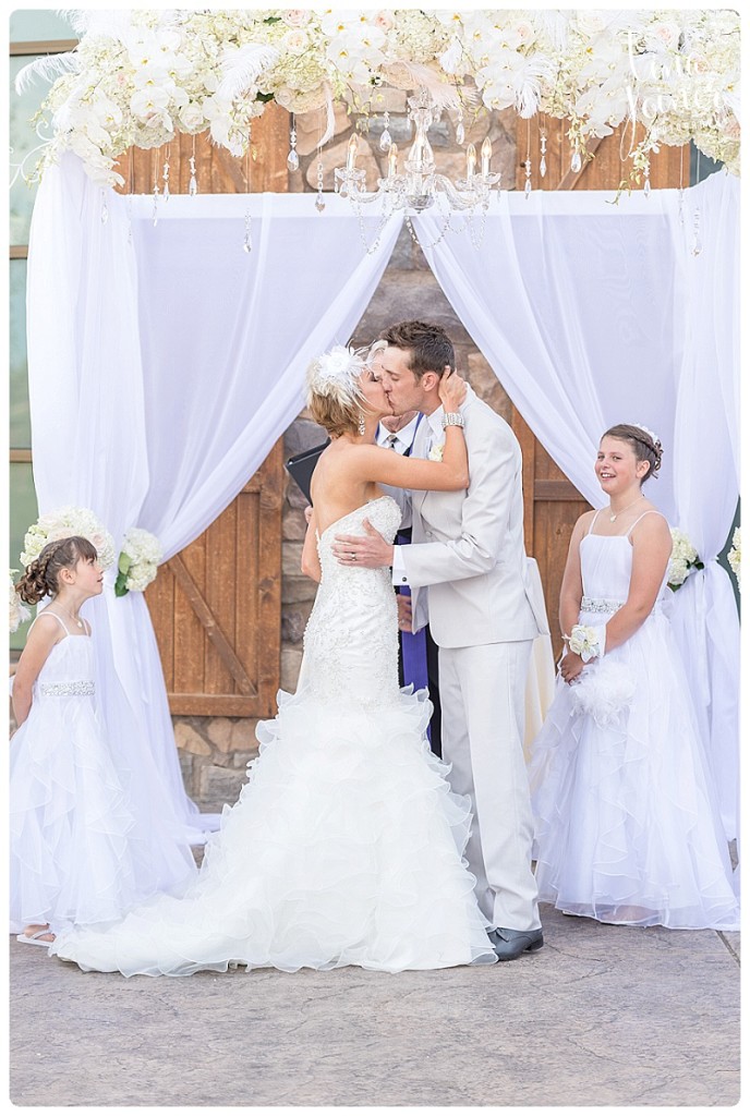 Bride and Groom kiss at flying horse club ceremony