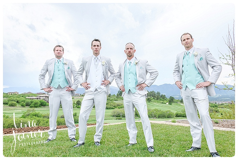 Groom and his groomsmen wearing white and light grey and teal