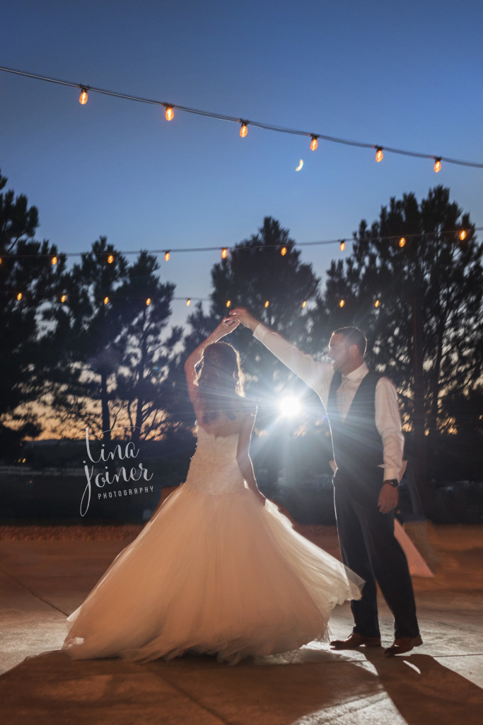 Stunning night photo with off camera flash behind couple dancing on their wedding day
