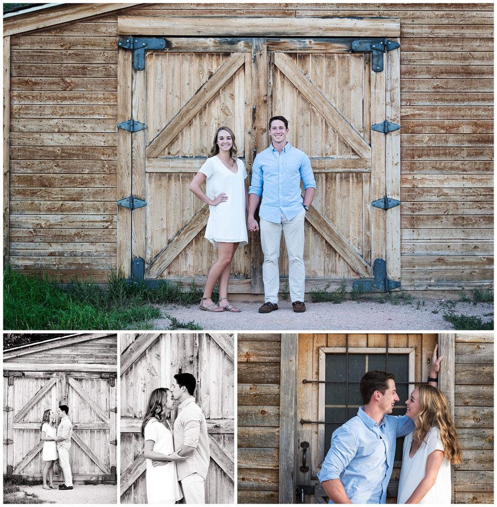 Couple stands in front of brown barn at Rock Ledge Ranch holding hands and embracing.