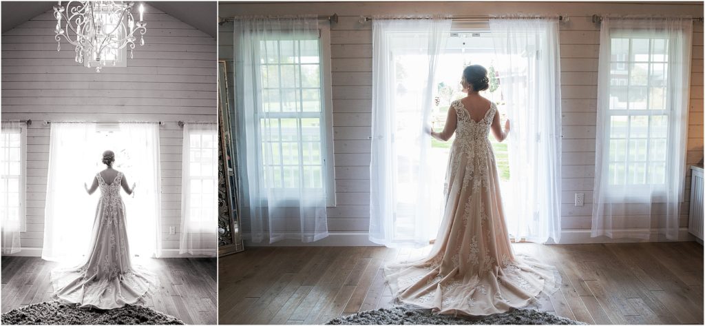 Stunning image of the back of the brides wedding dress as she looks out the window