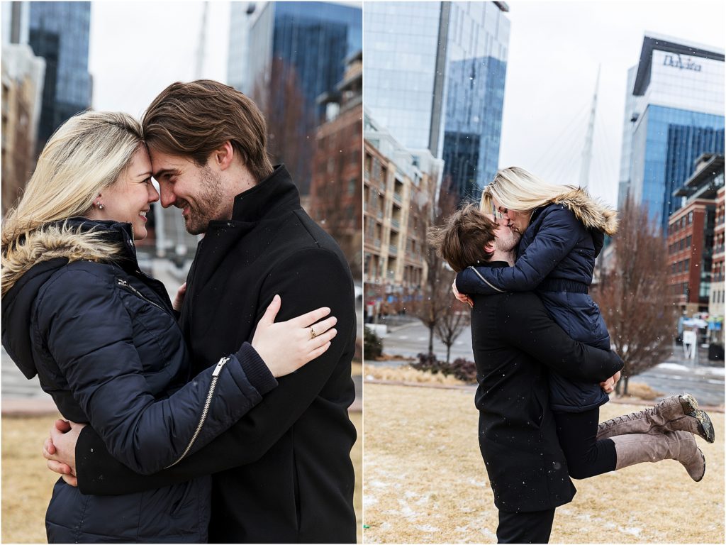 Engaged couple embrace and dance in a downtown park in winter