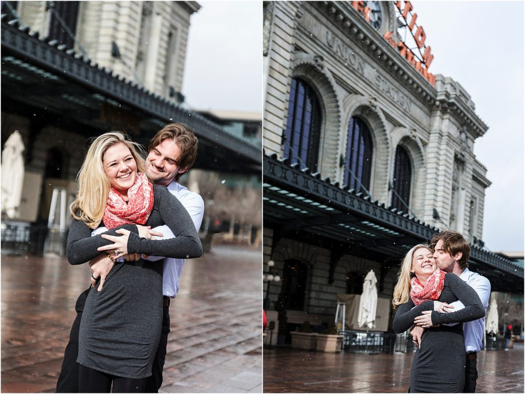 Engaged couple stand embracing in front of Union Station