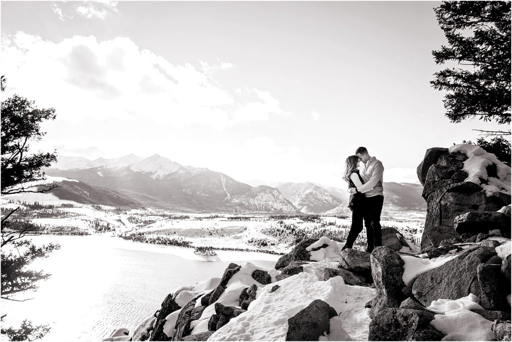 Couple stands with the iconic view from Sapphire Point near Breckenridge Colorado with stunning mountain views, couple embraces with foreheads together