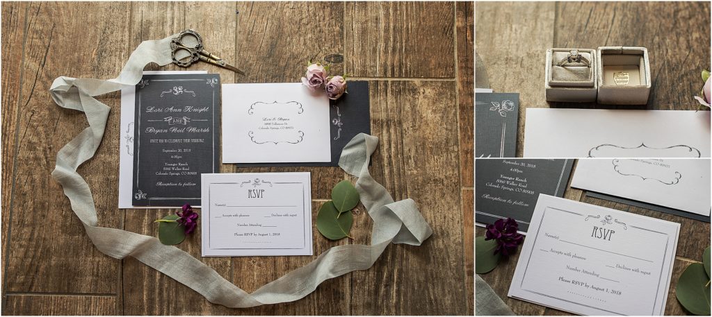 Beautifully styled lay flat of black and white wedding invitation with silk ribbon and velvet ring box and rosebuds from brides bouquet