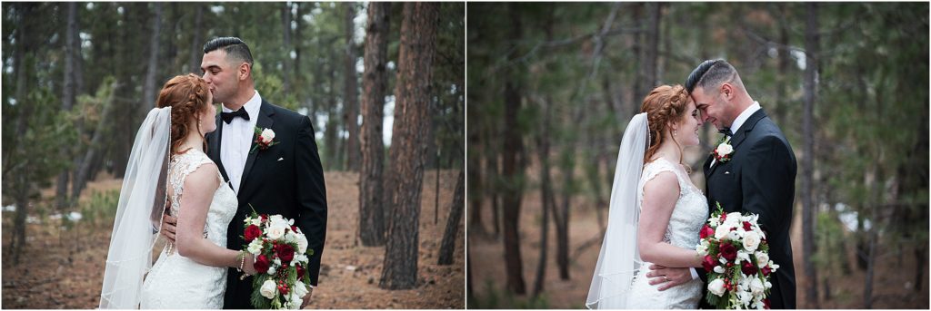 Cassidy and Jeff stand with their foreheads together in the forest after their wedding ceremony