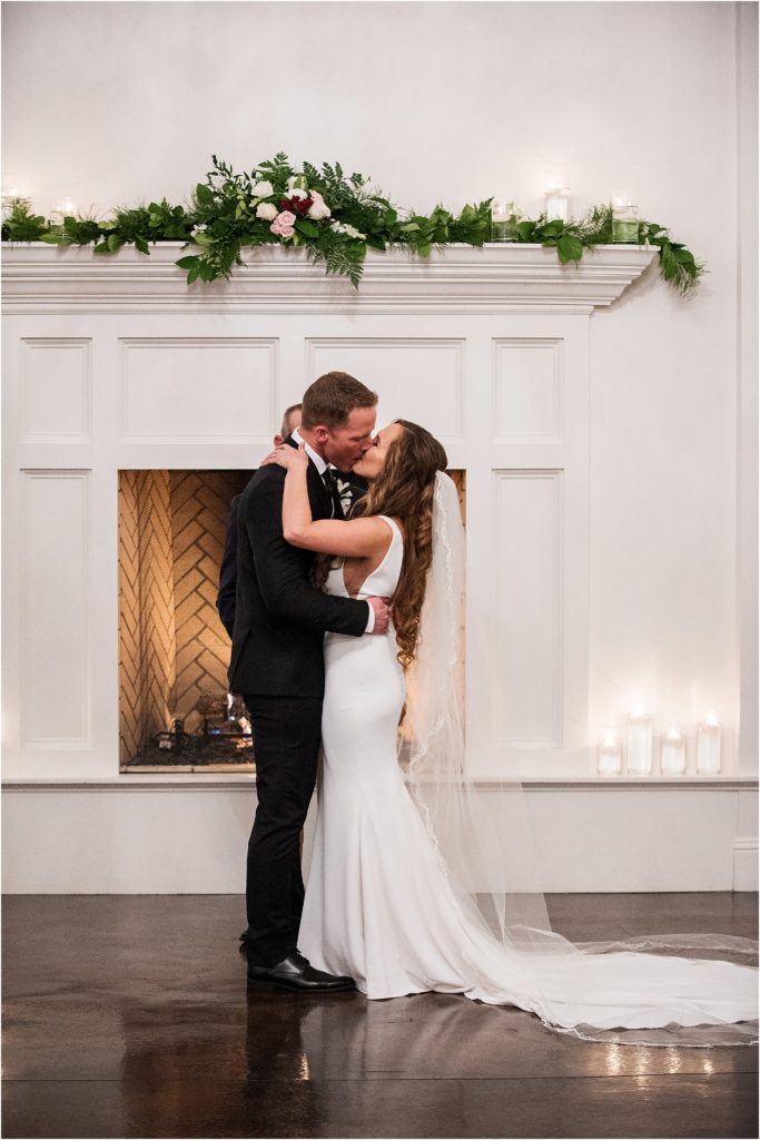 Bride and groom kiss romantically at the end of their wedding ceremony in Denver