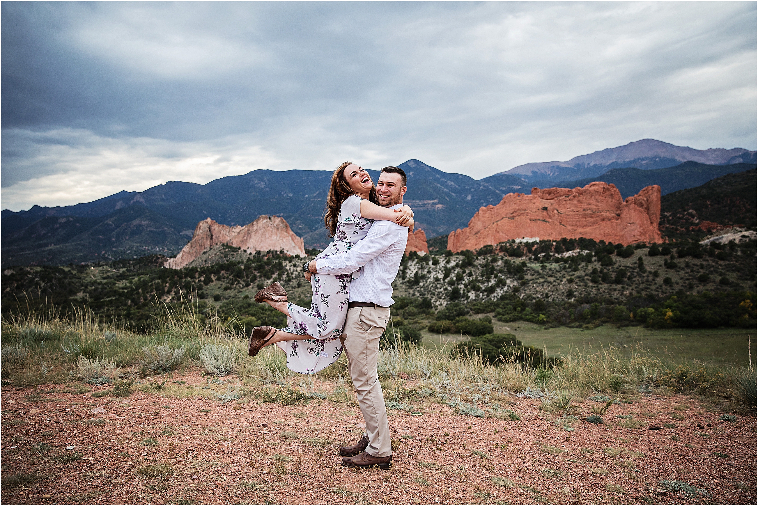 High School Sweethearts laughing and embracing at Mesa Overlook in Colorado Springs