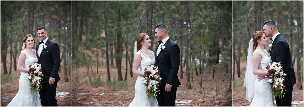Bride and groom stand in a forest with snow around at their winter holiday wedding