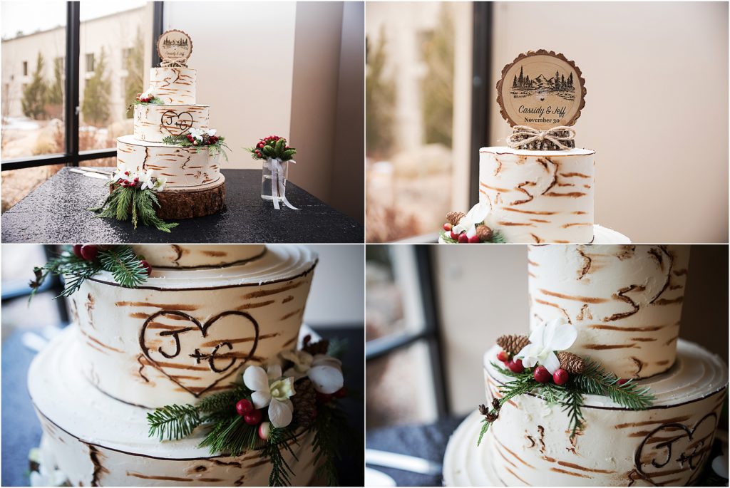 Jeff and Cassidy's wedding cake decorated with evergreen stems, white orchids and hypericum berries and pinecones, it is decorated to look like a tree trunk
