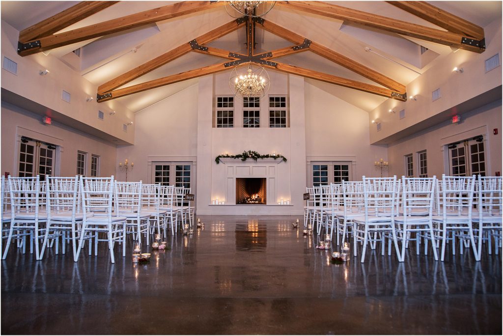 Stunning ballroom with vaulted ceilings and elegant chandeliers at The Manor House in Littleton, Colorado, fireplace mantel is decorated with holiday garland and candles