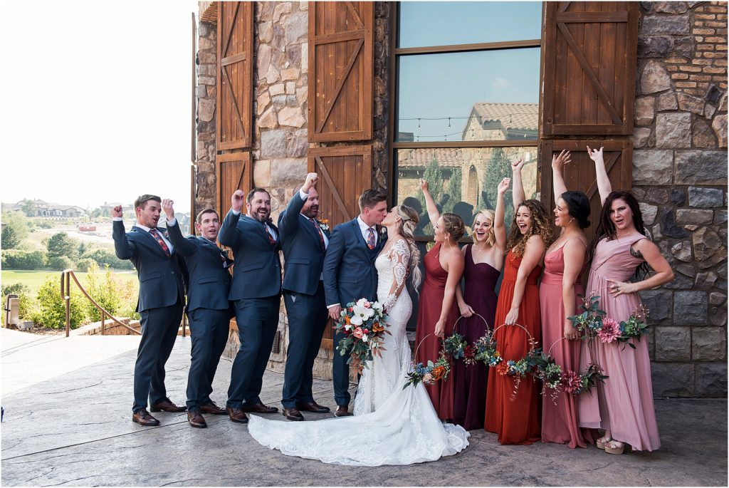 Bridal party cheers as Alex and Paige kiss after they are married
