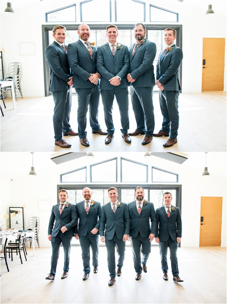 Groom and groomsmen stand together in a well lit room at the Flying Horse club in their suites and matching floral ties