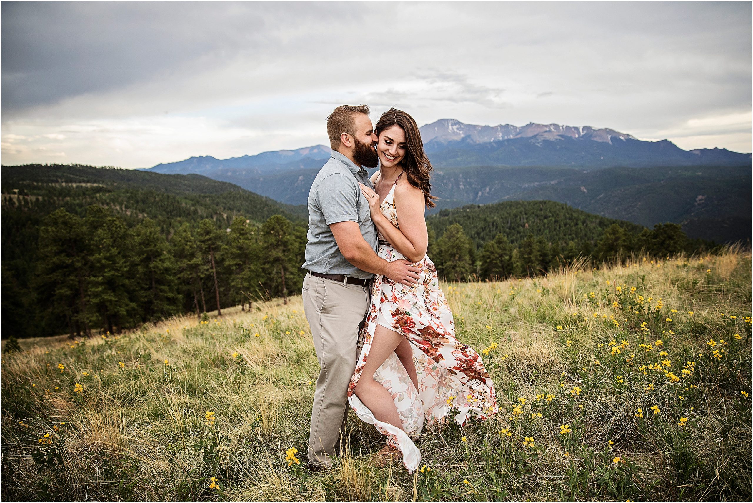 Taylor and Paige stand in a field of yellow wild flowers with lovely views of Pikes Peak