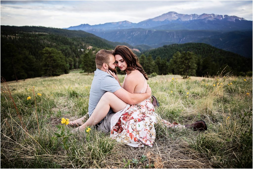 Taylor and Paige sit and embrace during their engagement session in the Rocky Mountains near Woodland Park.