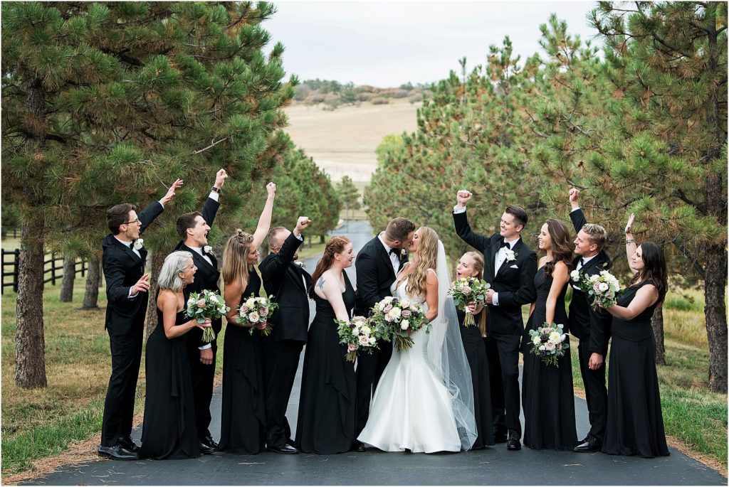 Bride and groom with their large bridal party at a colorado wedding.
