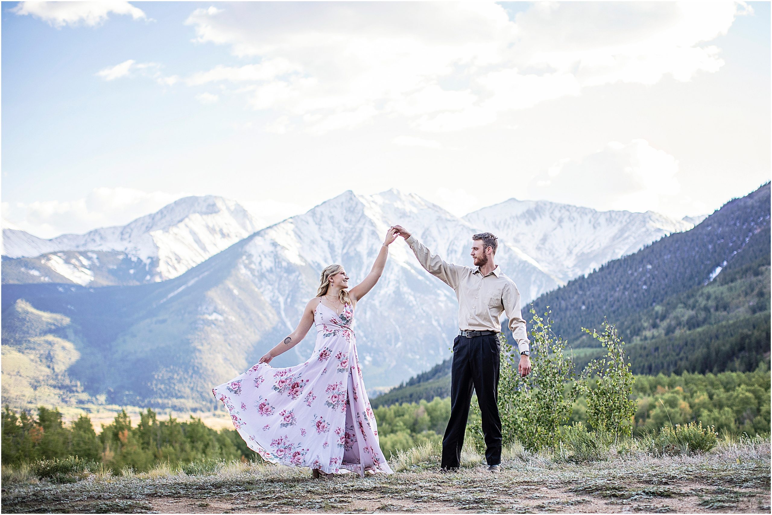 Nate and Darla dance on a mountain top in Colorado during their engagement session