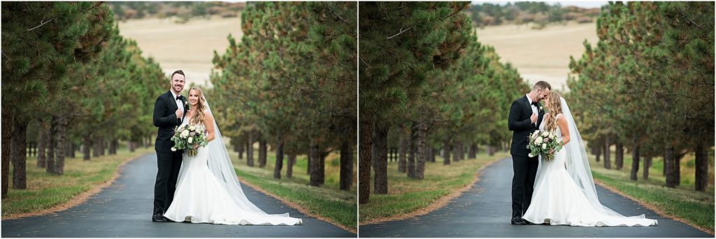 Josh and Lacy on roadway lined with evergreen trees on their wedding day.