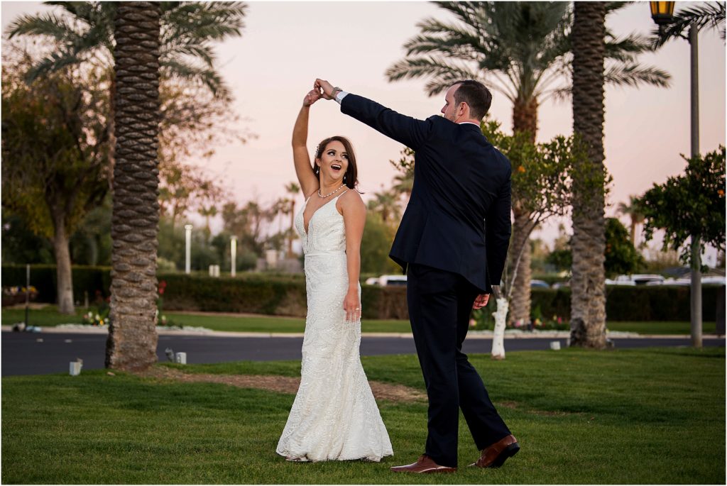 Bride and groom dance in the palm trees at their destination wedding at sunset