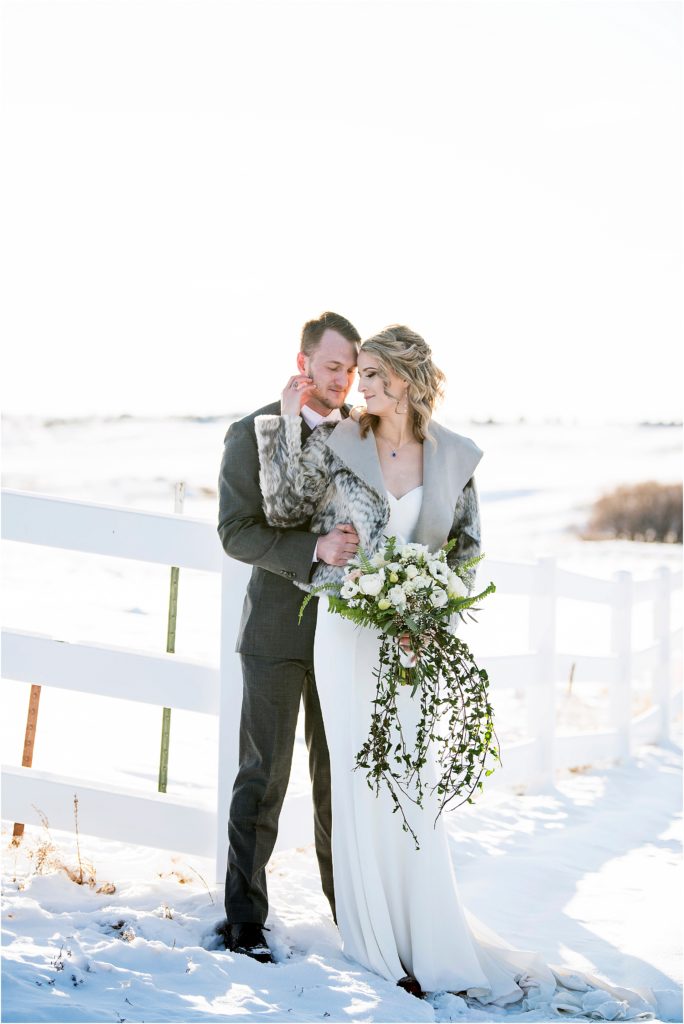 Bride and groom embrace during their winter wedding.