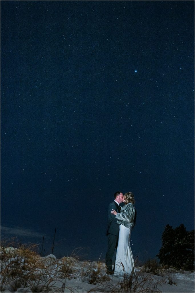 bride and groom at night with the stars up above.