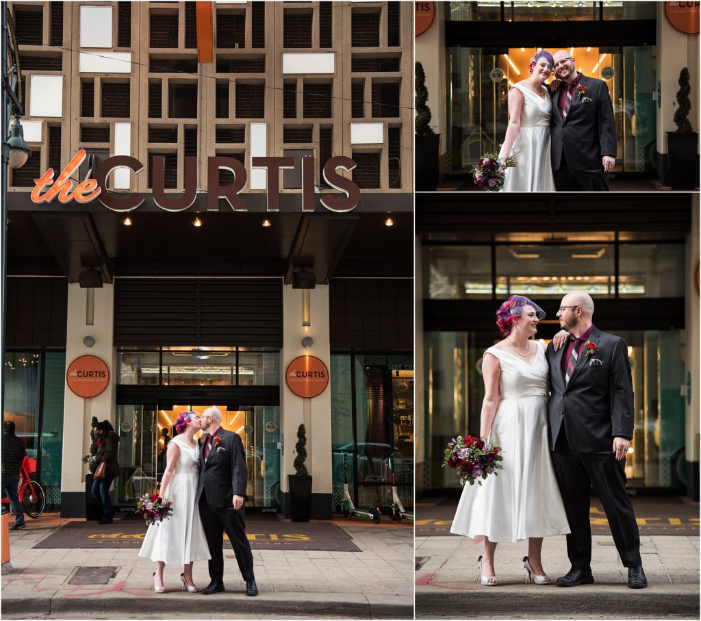 Couple kiss in front of the Curtis Hotel in Denver, Colorado