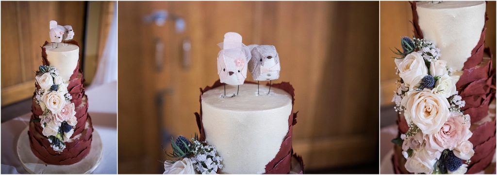 paper birds and florals on a wedding cake covered in burgundy fondant.