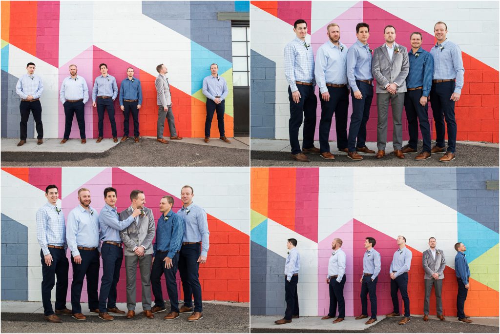 Groom and groomsmen have fun during their wedding portraits in front of colorful wall at the Space Annex in Denver