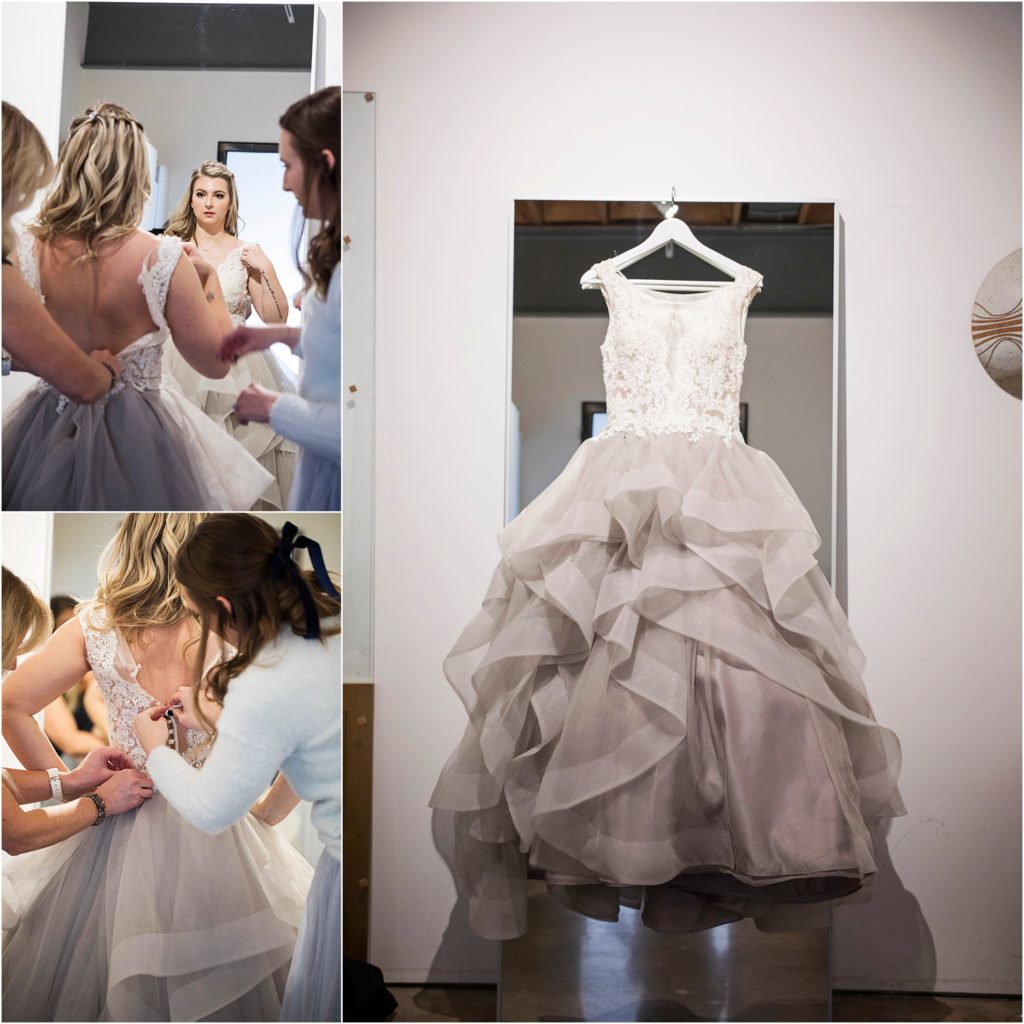 Bride gets ready while seeing herself in the mirror.