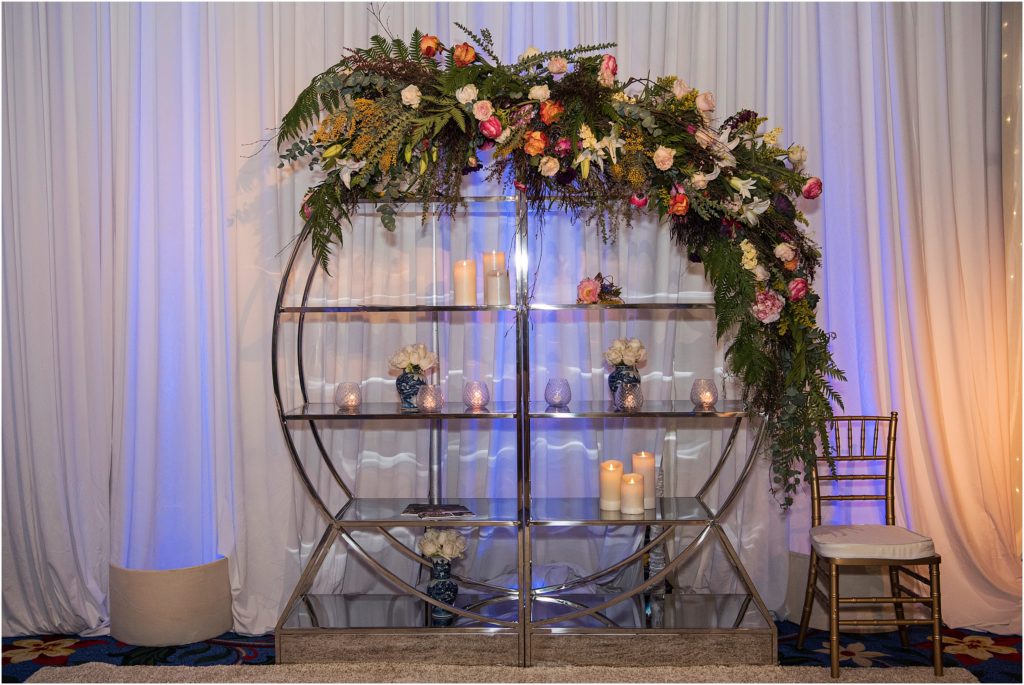 Circle shaped shelf decorated with stunning florals and candles at a Colorado Springs Bridal Show