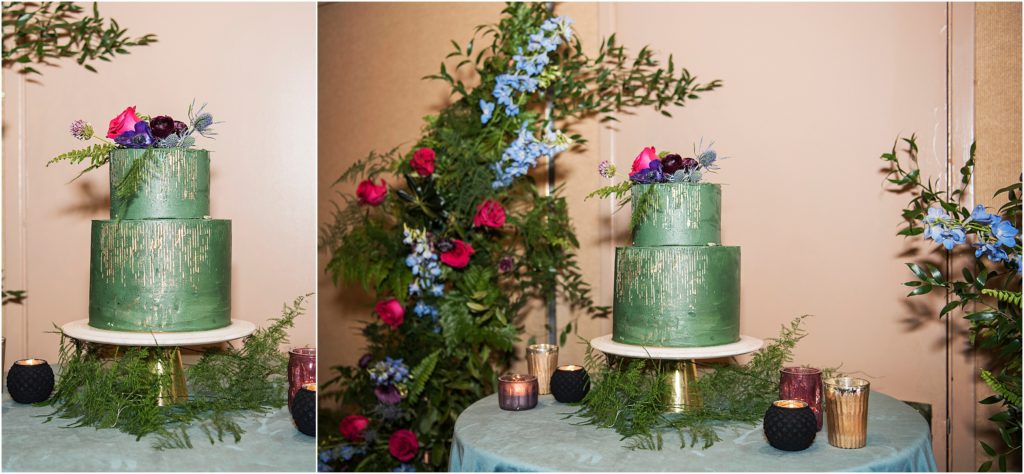 Stunning green and gold wedding cake surrounded by florals at the first bridal show since covid