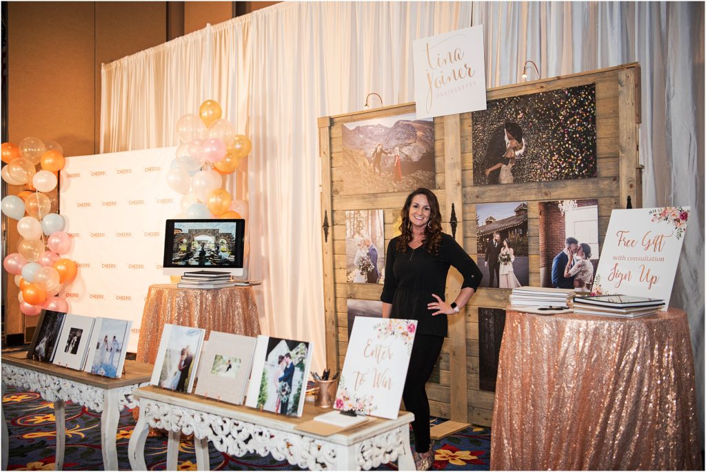 Tina Joiner stands in her display booth at the Cheers Bridal Show organized by Something New Boutique in Colorado Springs