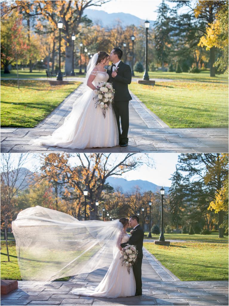 A full veil and bouquet adorns a bride as her new husband kisses her on their fall wedding day in Colorado