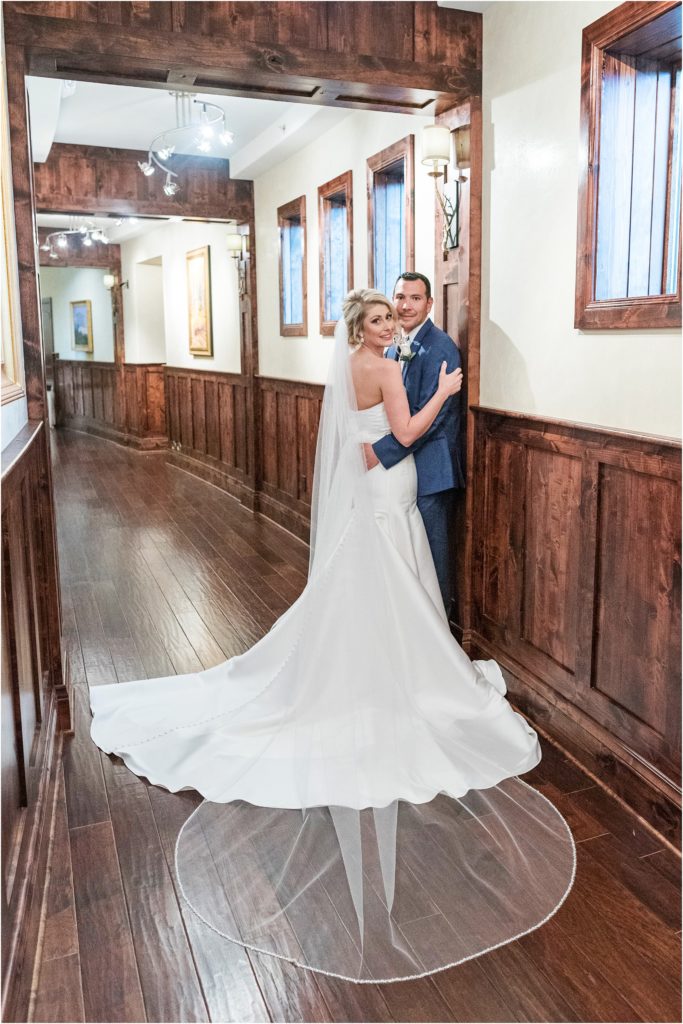 Bride and groom embrace in hallway at The Pinery in Colorado Springs