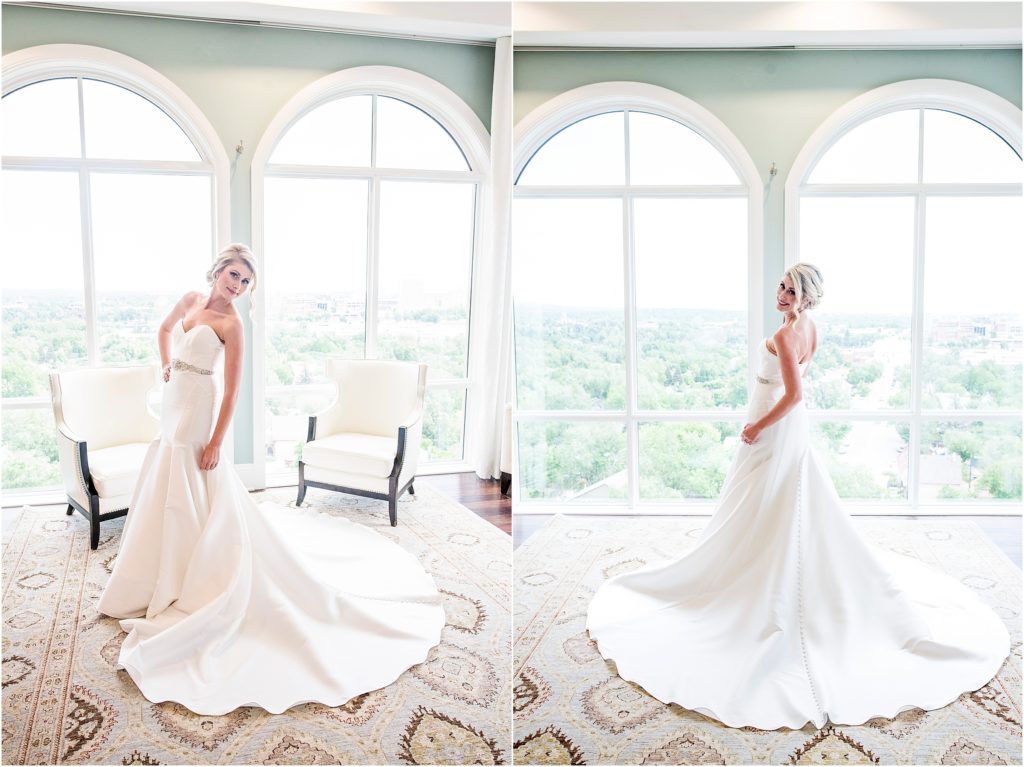 Blond bride in strapless wedding dress with rhinestone belt poses in bridal suite at The Pinery