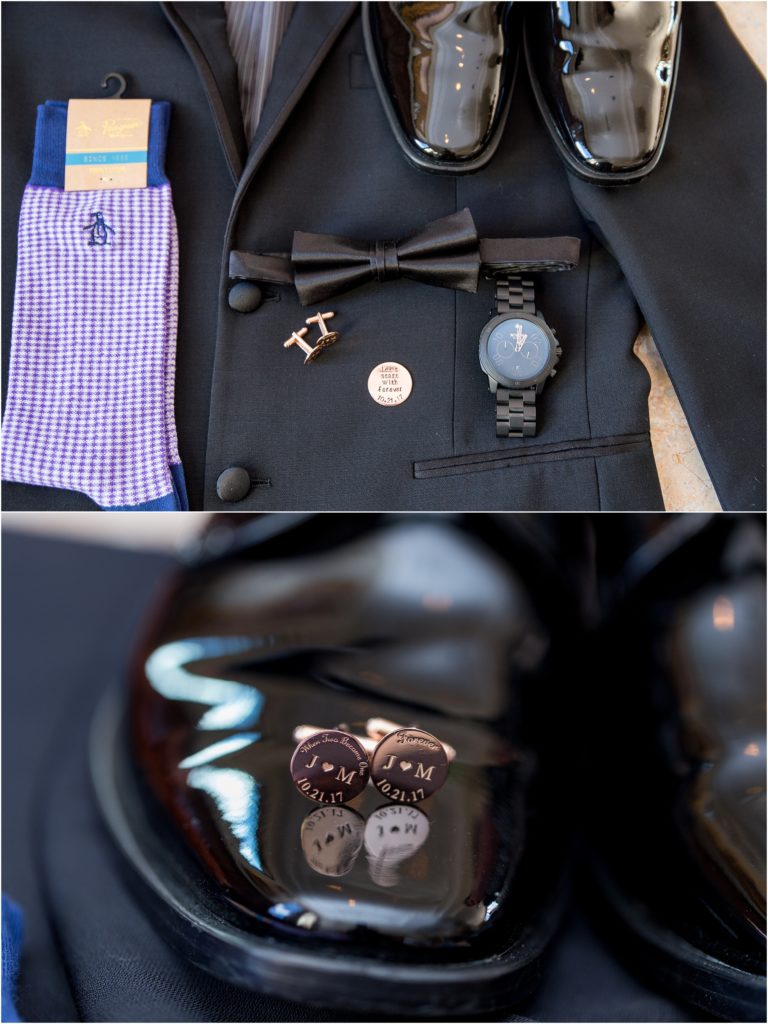 Dark groomswear with purple socks and sentimental messages on rose gold cufflinks are set out on display