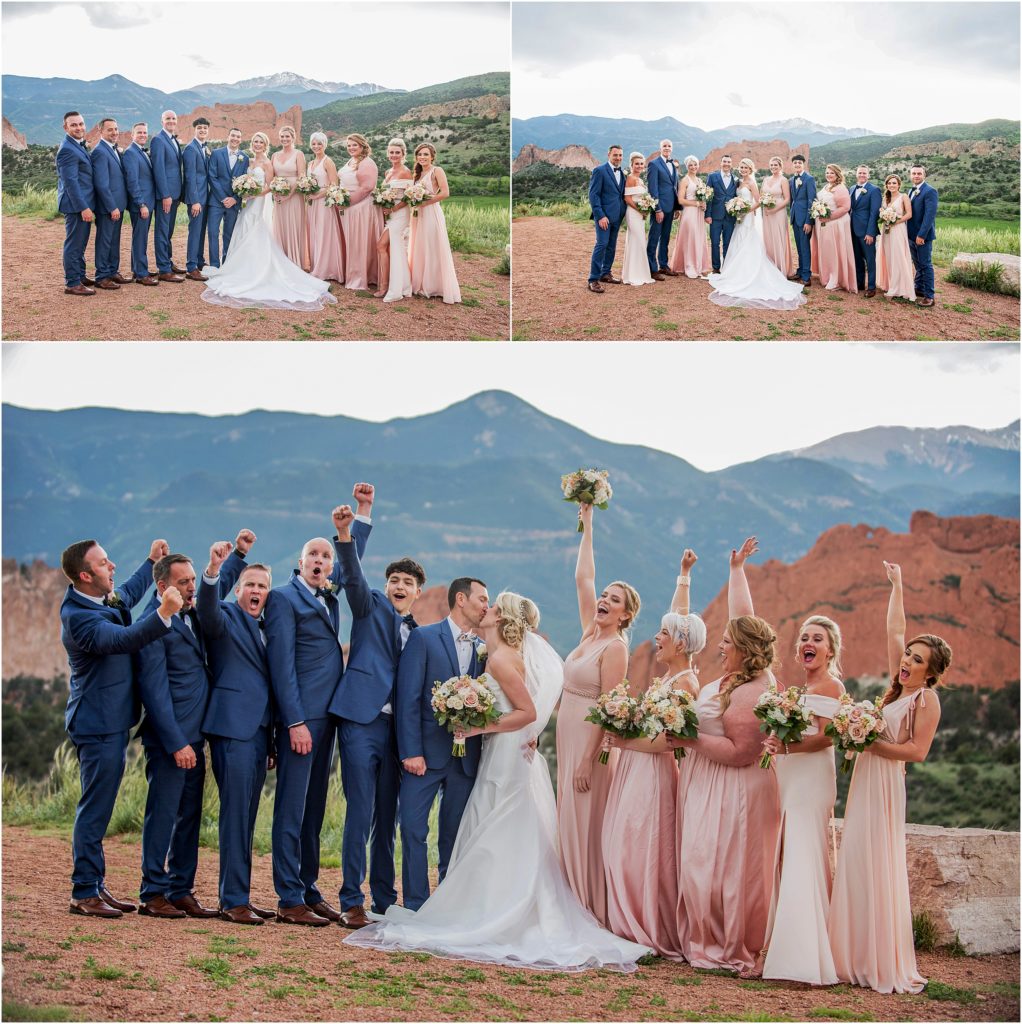 Wedding party wears navy blue and rose pink while taking photos at Garden of the Gods