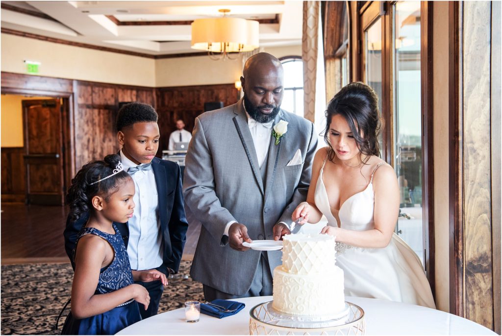 Kids watch as the bride and groom cut their wedding cake