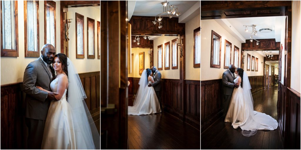 Bride and groom embrace in a romantic hallway stealing a moment away from their guests.