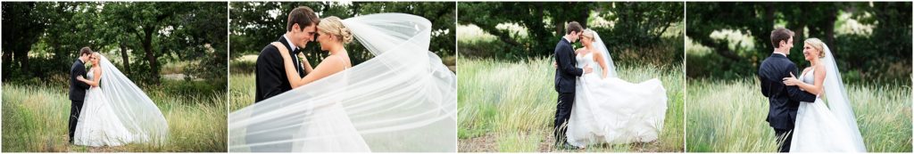 Bride and groom are in fun unique poses following their ceremony their outdoor photos capture the love they have for one another the tall grass and forest create a stunning backdrop bride's veil sweeps around the couple as they press their foreheads against one another the bride's dress is swept to the side as she is twirled by her groom