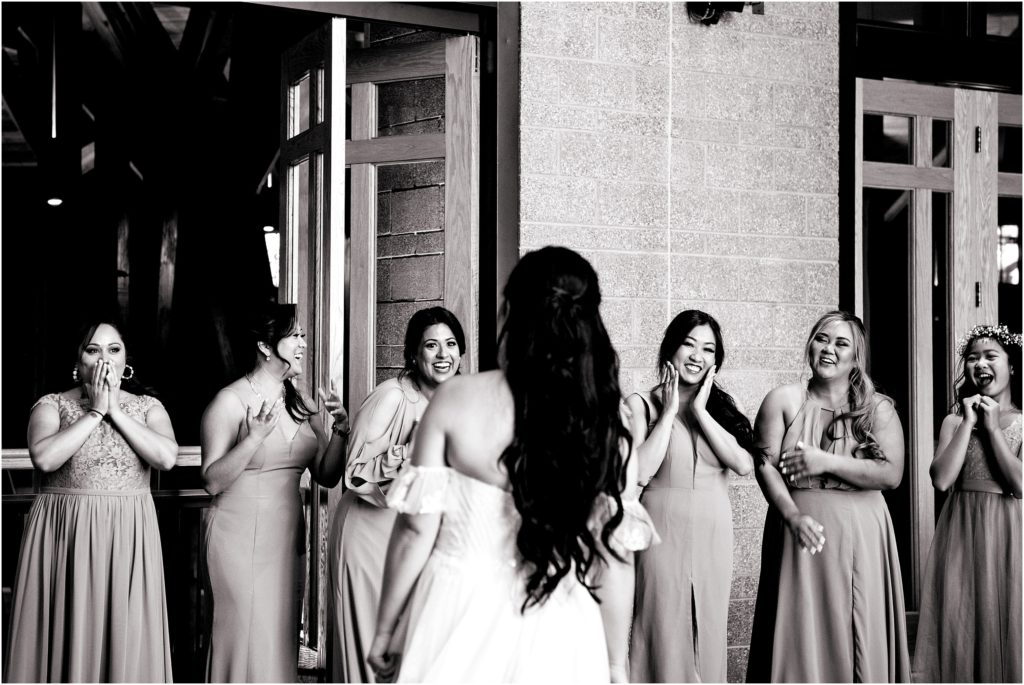 Bridesmaids are stunned when the bride reveals her wedding dress