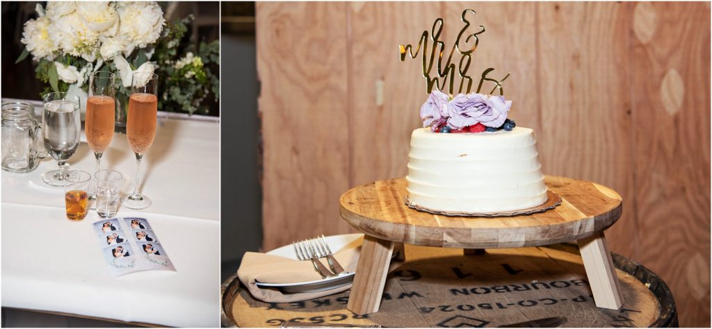Simple white wedding cake from Whole Foods sits atop a wooden stand on a barrel; pink champagne in flutes on bride and groom reception table