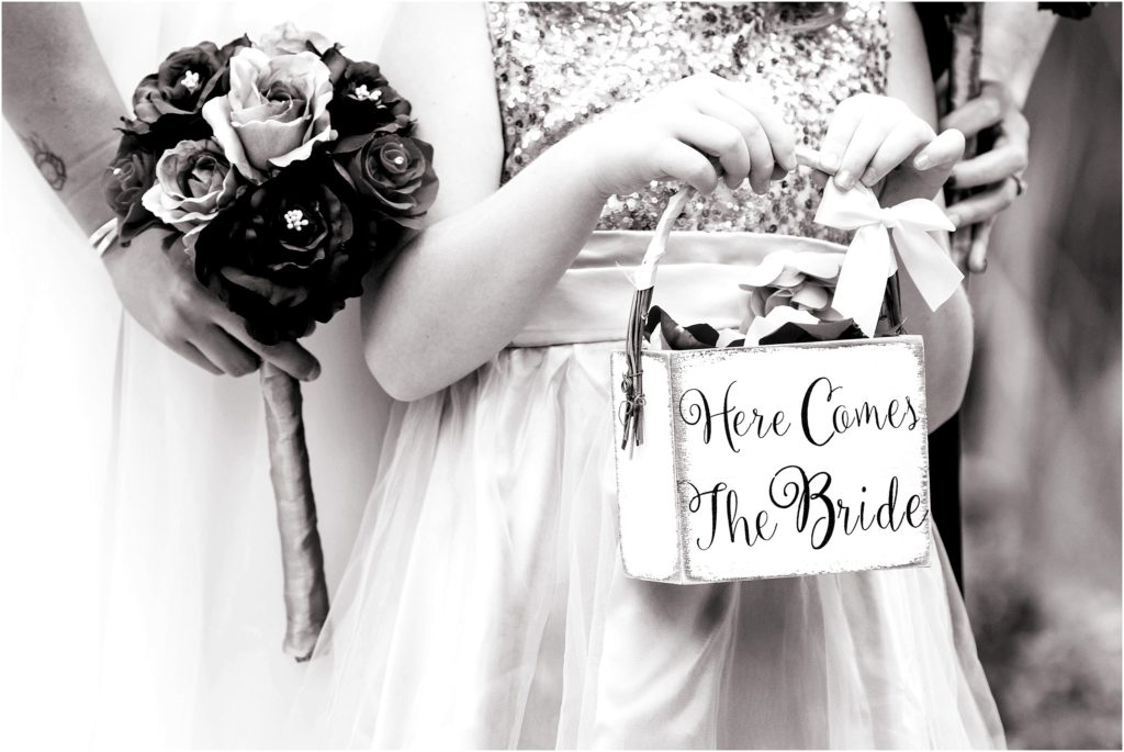 Cute flower girl box for outdoor ceremony that reads, "Here comes the bride."