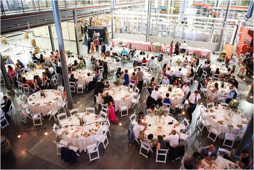 Large indoor wedding reception at Great Divide Barrel Bar has an industrial look
