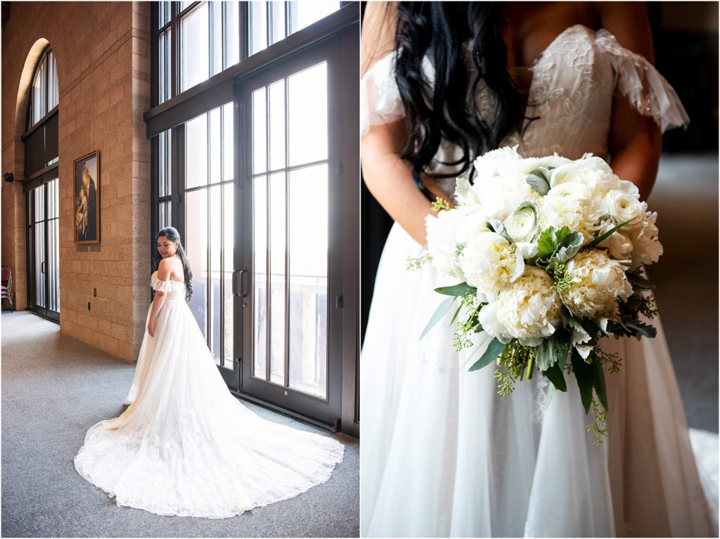Stunning wedding dress train is pictured in front of floor to ceiling windows, bride's bouquet made of white peonies and greenery compliments her white lace wedding dress