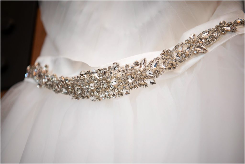 Simple wedding dress with stunning rhinestone detail around the waist
