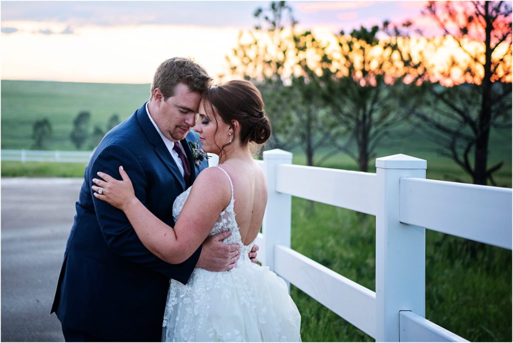 Summer sunset sets the stage for a magical wedding photo of the couple