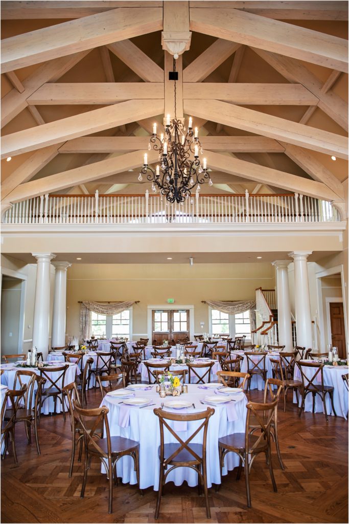 Stunning high ceilings and white beams create an impressive backdrop for this indoor wedding reeption